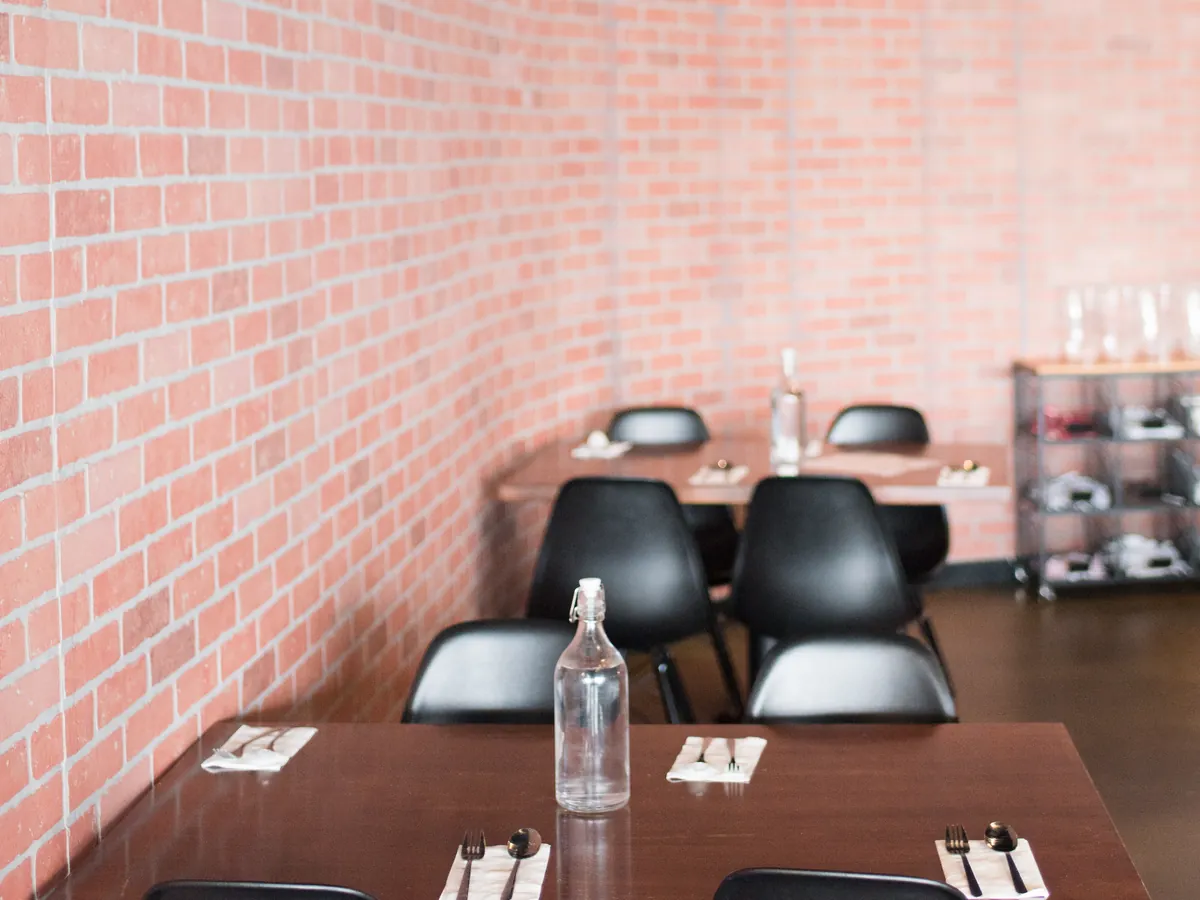 Tables set for a group inside Pique Thai
